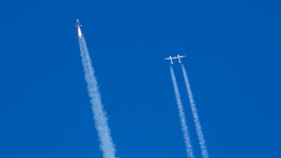 Virgin Galactic's rocket-powered plane Unity 22, left, flies past its mothership Eve on its way to the edge of space after taking off from Spaceport America, near Truth or Consequences, N.M., Thursday, Aug. 10, 2023.