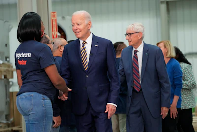 President Joe Biden and Wisconsin Gov. Tony Evers, are greeted by workers as they arrive at Ingeteteam Inc., in Milwaukee, Tuesday, Aug. 15, 2023.