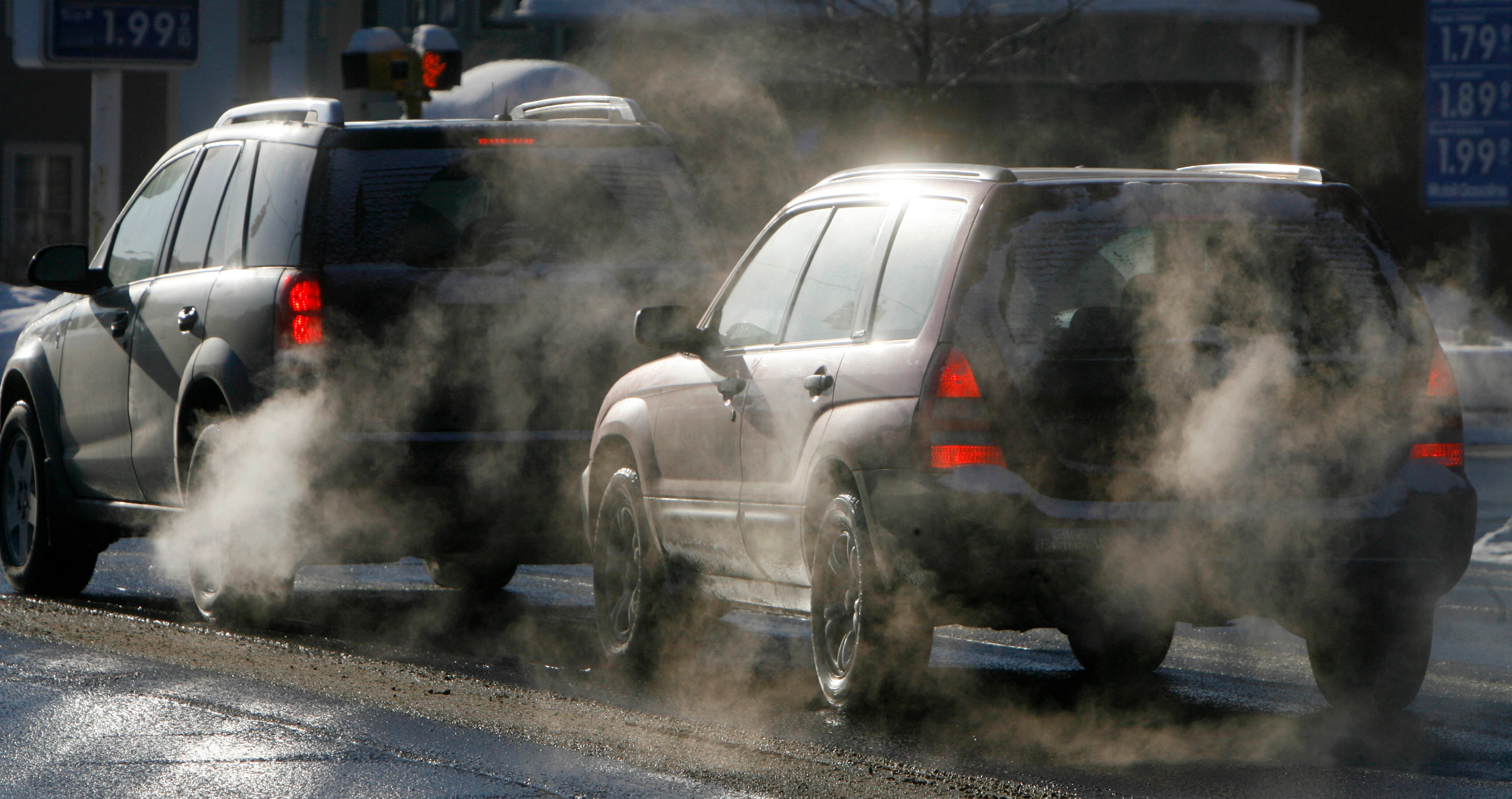Cars give off exhaust fumes in Montpelier, Vt., Monday, Jan. 26, 2009.