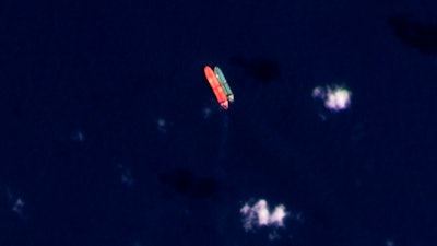 In this satellite photo provided by Planet Labs PBC, vessels identified as the Virgo, left, and the Suez Rajan, by the advocacy group United Against Nuclear Iran, are seen in the South China Sea on Feb. 13, 2022.
