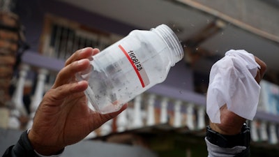 A Doctors Without Borders' worker releases laboratory-bred mosquitoes infected with bacteria that interrupt the transmission of dengue, in Tegucigalpa, Honduras, Thursday, Aug. 24, 2023.