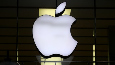 The Apple logo is illuminated at a store in the city center in Munich, Germany, on Dec. 16, 2020.
