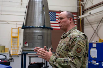 In this image provided by the U.S. Air Force, Chief Master Sgt. Andrew Zahm speaks in front of the top of a Minuteman III intercontinental ballistic missle shroud at F.E. Warren Air Force Base, Wyo., Aug. 16, 2023.