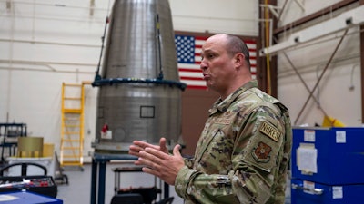 In this image provided by the U.S. Air Force, Chief Master Sgt. Andrew Zahm speaks in front of the top of a Minuteman III intercontinental ballistic missle shroud at F.E. Warren Air Force Base, Wyo., Aug. 16, 2023.