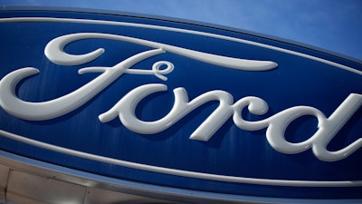 The Ford company logo is seen, Oct. 24, 2021, on a sign at a Ford dealership in southeast Denver. Ford is keeping it in the family.