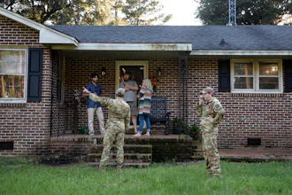Airmen from Joint Base Charleston speak to a family living right next to the site of a crashed F-35 about the operation to recover the fighter jet and requests for the family in Williamsburg County, S.C., on Monday, Sept. 18, 2023.