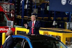 President Donald Trump claps as he walks to the podium to speak at Ford's Rawsonville Components Plant that has been converted to making personal protection and medical equipment, Thursday, May 21, 2020, in Ypsilanti, Mich.