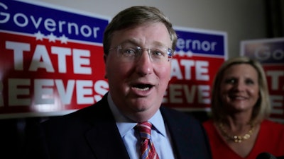 With wife Elee Reeves at his side, Mississippi Gov. Tate Reeves speaks in Jackson, Miss.