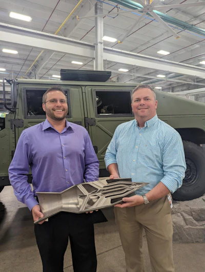 John Keogh, technical lead, and project manager Brad Friend hold a cut section of the LIFT Hypersonic Challenge 3D printed ramjet. The project was centered at the American Lightweight Materials Manufacturing Innovation Institute’s 100,000-square-foot facility in Detroit, Michigan.