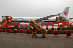 Dancers perform a lion dance near the 100th A320 airplane assembled at the Tianjin plant of Airbus in north China's Tianjin Municipality on Aug. 31, 2012.