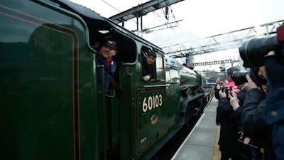 The Flying Scotsman, a historical locomotive, arrives at Kings Cross railway station in London to pick up passengers for its journey to York, Thursday, Feb. 25, 2016.
