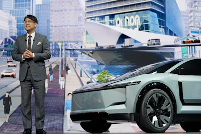 Toyota Motor Corp. CEO Koji Sato, standing next to the SUV-type FT-3e, speaks during a briefing on the media day at the Japan Mobility Show in Tokyo, Wednesday, Oct. 25, 2023.
