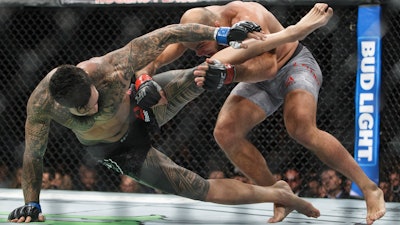 ILir Latifi, right, of Sweden, takes down Tyson Pedro, of Australia, during their bout at UFC 215, Edmonton, Alberta, Sept. 9, 2017.