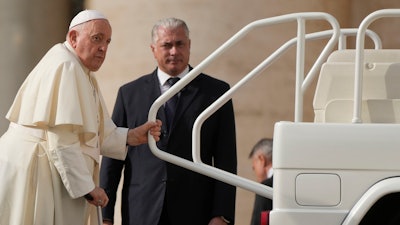 Pope Francis leaves at the end of the weekly general audience in St. Peter's Square, at the Vatican, Wednesday, Nov. 15, 2023.