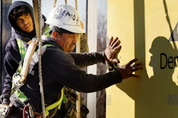 Workers apply sheathing to the exterior of a new multifamily residential building, Boston, Nov. 3, 2023.