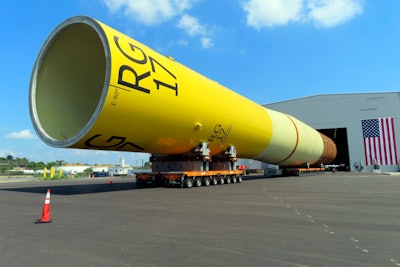 A huge foundation for an Orsted offshore wind turbine, called a monopile, sits atop wheeled movers in Paulsboro, N.J., July 6, 2023.