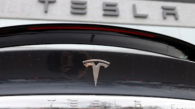 The company logo shines off the rear deck of an unsold 2020 Model X at a Tesla dealership in Littleton, Colo, on April 26, 2020.