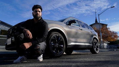 Shalinder Singh poses for photos in front of a 2024 Honda CR-V Hybrid in Sunnyvale, Calif., Monday, Dec. 11, 2023.
