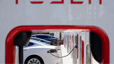 Tesla vehicles charge at a station in Emeryville, Calif., Aug. 10, 2022.
