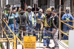Mineworkers at the entrance of a goldmine in Springs, near Johannesburg, South Africa, Wednesday, Oct. 25, 2023.