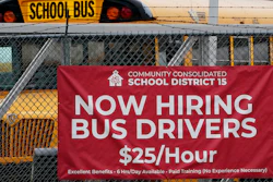 A hiring sign is displayed at a school in Palatine, Ill., Wednesday, Nov. 8, 2023. On Thursday, the Labor Department reports on the number of people who applied for unemployment benefits last week.