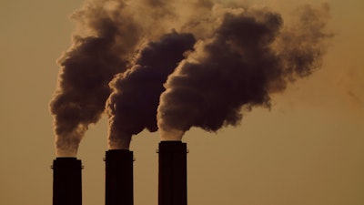 Emissions rise from the smokestacks at the Jeffrey Energy Center coal power plant as the sun sets, near Emmett, Kan., Sept. 18, 2021. The Supreme Court will hear arguments in February on whether the Environmental Protection Agency can continue enforcing its anti-air-pollution “good neighbor” rule in 10 states, an effort to restrict smokestack emissions from power plants and other industrial sources that burden downwind areas with smog-causing pollution.