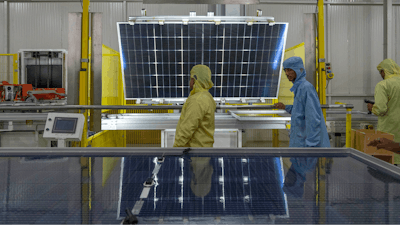 Employees work at the Adani New Industries Limited, one of India's largest solar panels and wafers manufacturing facility in the port town of Mundra in Western India's Gujarat state, India, Wednesday, Sept. 20, 2023.