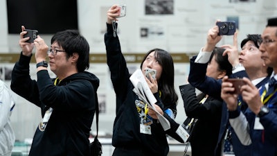 Staff of Japan Aerospace Exploration Agency (JAXA) watch a live streaming of the pinpoint moon landing operation by the Smart Lander for Investigating Moon (SLIM) spacecraft observe a live streaming at JAXA's Sagamihara Campus Saturday, Jan. 20, 2024, in Sagamihara near Tokyo.