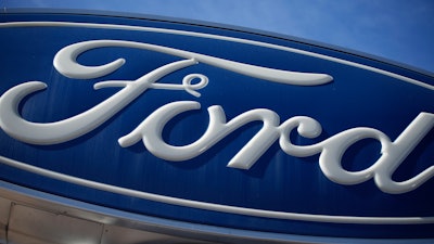 The Ford company logo is seen, Oct. 24, 2021, on a sign at a Ford dealership in southeast Denver.