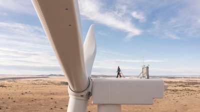 This undated image provided by GE Vernova shows a worker atop a wind turbine at the Borderland Wind Project in western New Mexico near the Arizona state line.
