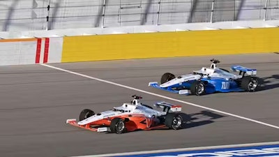 An autonomous race car built by the Technical University of Munich prepares to pass the University of Virginia’s entrant.
