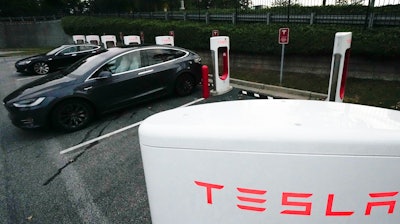 A Tesla vehicles charge, Wednesday, Sept. 27, 2023, in Woodstock, Ga. Tesla reports their earnings on Wednesday, Jan. 24, 2024.