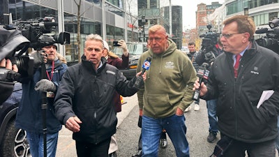 Massachusetts State Police Sgt. Gary Cederquist, center, leaves federal court in Boston, Jan 30, 2024.