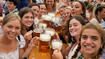 Women pose for a photo at the 188th Oktoberfest in Munich, Sept. 16, 2023.