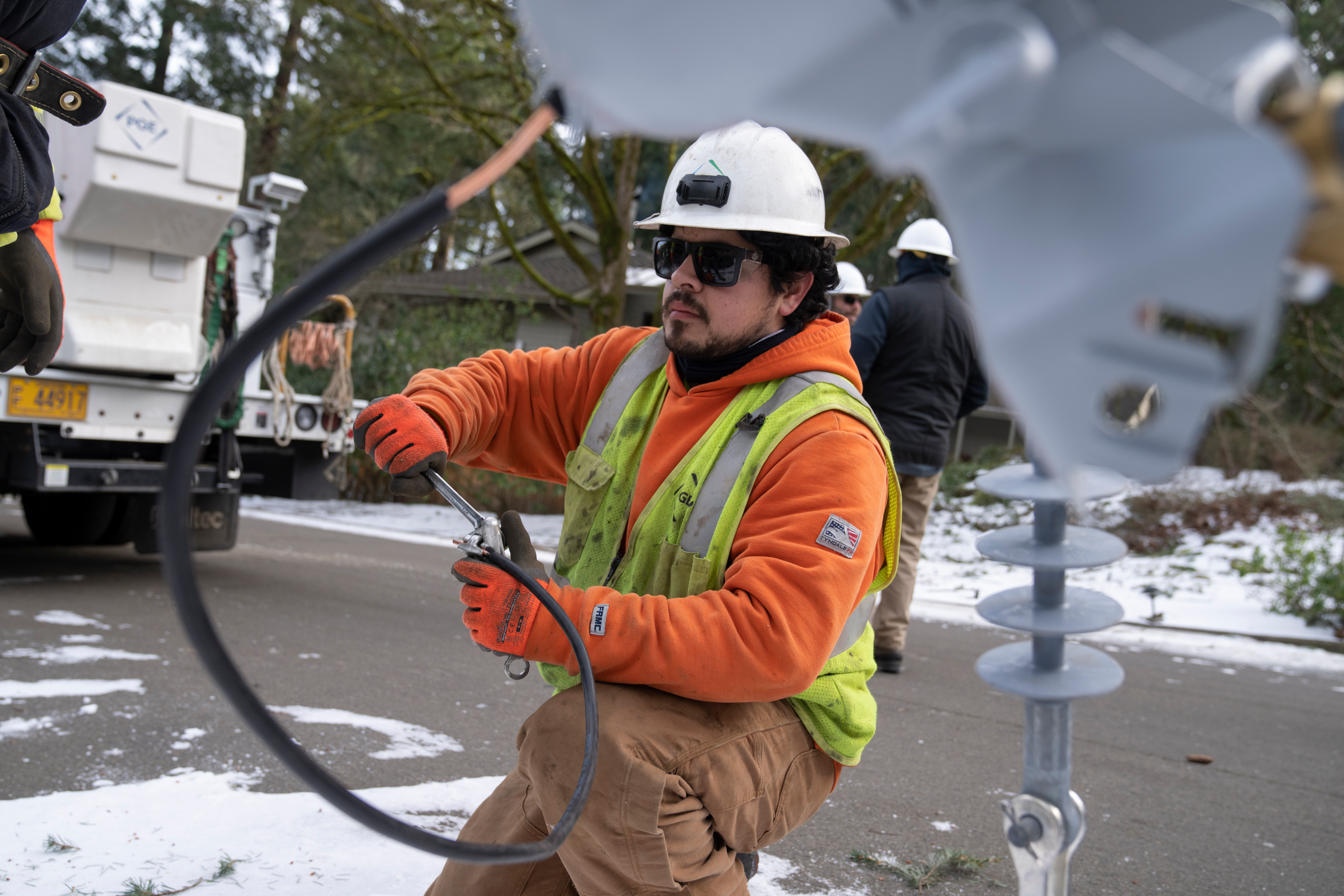 A worker from Portland General Electric replaces a power line in Lake Oswego, Ore., Jan. 16, 2024.