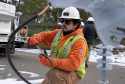 A worker from Portland General Electric replaces a power line in Lake Oswego, Ore., Jan. 16, 2024.