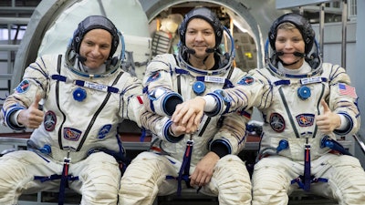 From left: CSA astronaut David Saint Jacques, Russian cosmonaut Оleg Kononenko and U.S. astronaut Anne McClain pose for a photo before their final preflight practical examination in a mock-up of a Soyuz space craft at Russian Space Training Center in Star City, outside Moscow, Russia, Wednesday, Nov. 14, 2018.
