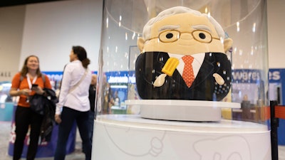 The Squishmallows booth sells toys modeled after Warren Buffett, pictured, and Charlie Munger in the exhibit hall for the Berkshire Hathaway annual meeting, Saturday, May 6, 2023, in Omaha, Neb.
