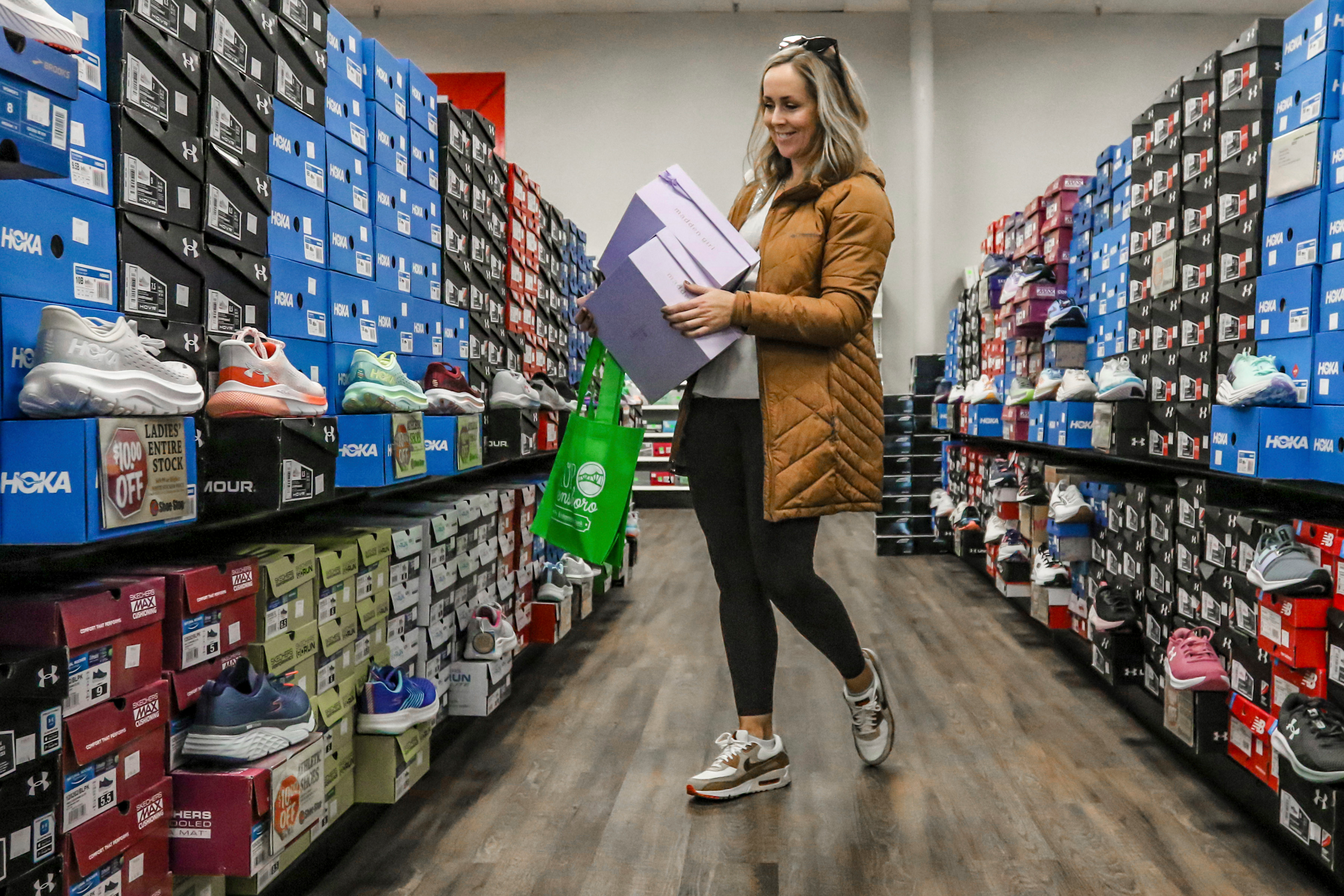 Ashley Crafton looks at tennis shoes at Shoe Stop in Wesleyan Park Plaza, Owensboro, Ky., Nov. 25, 2023.
