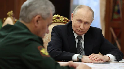 Russian President Vladimir Putin, right, listens to Russian Defense Minister Sergei Shoigu during their meeting at the Kremlin in Moscow, Russia, Tuesday, Feb. 20, 2024.