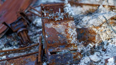 An old cash register sits among the charred remains of a home burned in the Slater Fire in Happy Camp, Calif., Oct. 6, 2021. The U.S. government has threatened to sue a unit of Warren Buffett’s Berkshire Hathaway to recover nearly $1 billion of costs related to the wildfires in 2020 in southern Oregon and northern California.