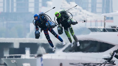 Jet suit pilots race in Dubai, United Arab Emirates, Wednesday, Feb. 28, 2024. Dubai on Wednesday hosted what it called its first-ever jet suit race. Racers zipped along a route with the skyscrapers of Dubai Marina looming behind them, controlling the jet engines on their hands and their backs.