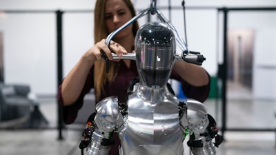 AI engineer Jenna Reher works on humanoid robot Figure 01 at Figure AI's test facility in Sunnyvale, Calif., Oct. 3, 2023.