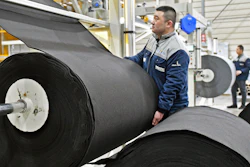 Workers produce car mats in a factory of car interior pieces in Yantai in east China's Shandong province, on Feb. 21, 2024.