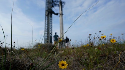 Visitors look on as SpaceX's Starship, the world's biggest and most powerful rocket, stands ready for a scheduled launch from Starbase in Boca Chica, Texas, Wednesday, April 19, 2023.