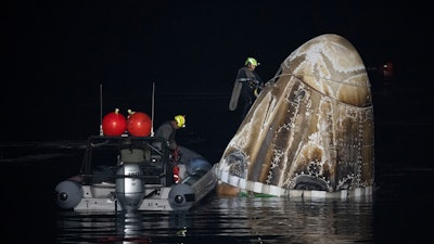 Support teams work around the SpaceX Dragon Endurance spacecraft shortly after it landed with NASA astronaut Jasmin Moghbeli, European Space Agency astronaut Andreas Mogensen, Japan Aerospace Exploration Agency astronaut Satoshi Furukawa, and Russia cosmonaut Konstantin Borisov aboard in the Gulf of Mexico off the coast of Pensacola, Fla., Tuesday, March 12, 2024.