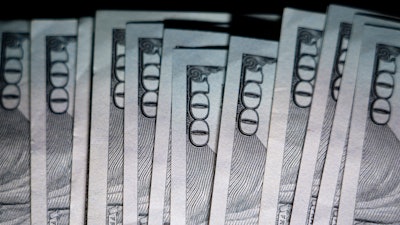 U.S. $100 bills are seen, Thursday, July 14, 2022, in Marple Township, Pa.