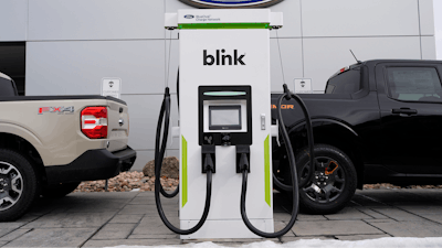 Electric vehicle chargers sit outside a Ford dealership, Jan. 21, 2024, in Broomfield, Colo.
