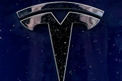 A Tesla electric vehicle emblem is affixed to a passenger vehicle Sunday, Feb. 21, 2021, in Boston.