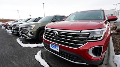 A line of unsold 2024 Atlas sports-utility vehicles sits at a Volkswagen dealership Sunday, March 17, 2024, in Denver. Most automakers who sell new vehicles in the U.S. report first-quarter sales numbers on Tuesday, April 2, 2024. Sales are expected to be surprisingly strong despite high interest rates.